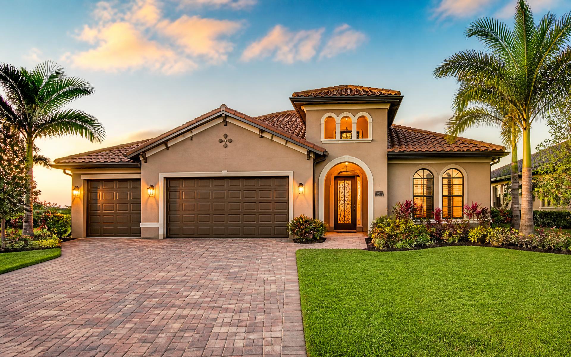Sunlit Southwest Florida rental home framed by palm trees